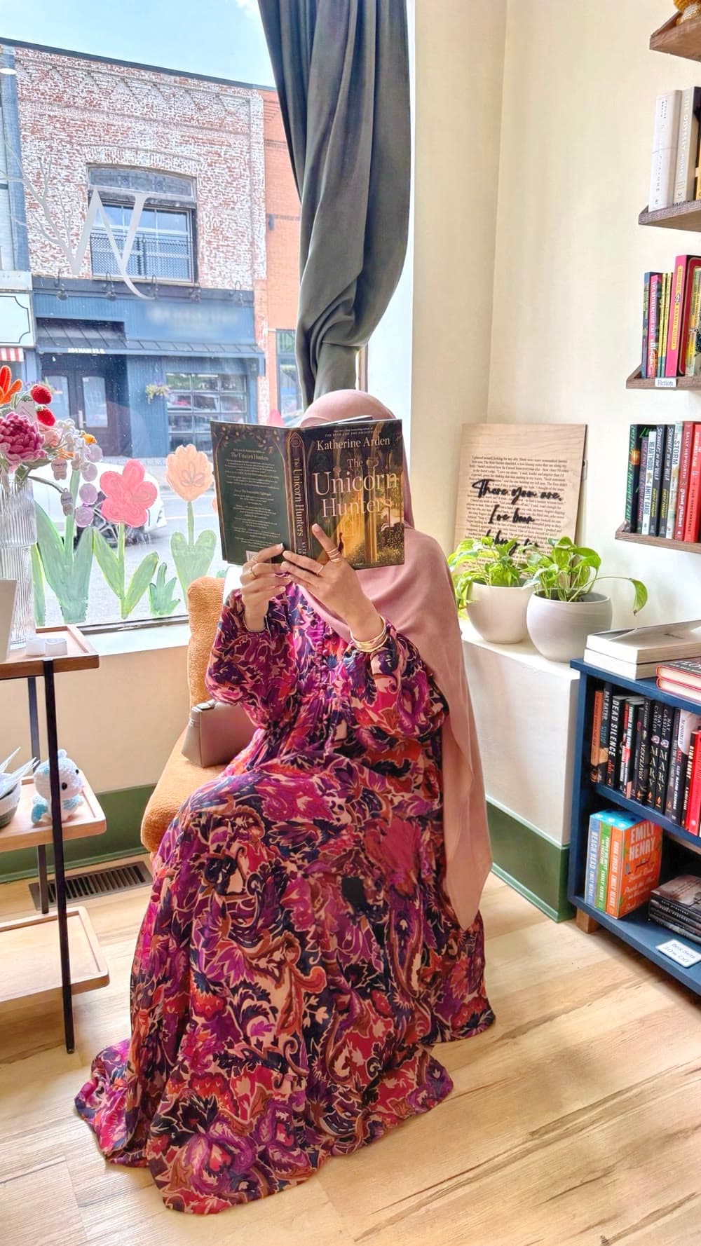 Reading a novel by a bookshop window